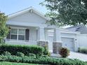 Charming home exterior with a well-maintained front yard and a covered porch at 11408 Satire St, Orlando, FL 32832