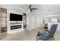Modern living room featuring an electric fireplace and decorative wall accents at 1178 Vineland Pl, Lake Mary, FL 32746