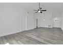 Spacious living room with modern flooring, ceiling fan, and ample natural light at 1406 Sean Ct, St Cloud, FL 34772
