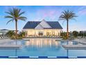 Community pool surrounded by palm trees and plenty of lounge chairs at 1508 Stonecliff Dr, Apopka, FL 32703