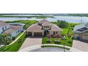 Beautiful home with lush landscaping, a three-car garage and a circular driveway at 15344 Johns Lake Pointe Blvd, Winter Garden, FL 34787