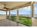 Covered patio featuring tile flooring, ceiling fan and a scenic view at 15344 Johns Lake Pointe Blvd, Winter Garden, FL 34787