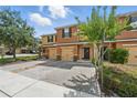 Inviting townhome featuring a well-maintained, colorful exterior and paver driveway at 1575 Downy Birch Ln, Longwood, FL 32750