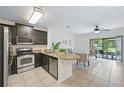 Open kitchen featuring stainless steel appliances and granite countertops at 1575 Downy Birch Ln, Longwood, FL 32750