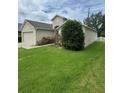 Lovely home featuring a well-maintained lawn, tidy landscaping and a white picket fence enhancing curb appeal at 1868 Hammock Moss Dr, Orlando, FL 32820