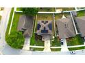 Aerial view of a home with solar panels and a well-manicured yard in a suburban neighborhood at 208 Oleander St, Winter Haven, FL 33881