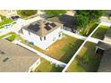Aerial view of a fenced backyard with a well-kept lawn, landscaping, and chairs on the grass at 208 Oleander St, Winter Haven, FL 33881