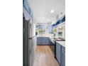 Efficient kitchen with modern stainless steel appliances, wood floors and bright lighting at 244 N Leavitt Ave, Orange City, FL 32763
