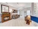 Bright living room with a fireplace, tile flooring, and elegant decor at 2500 Castle Pines St, Clermont, FL 34711