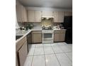 Well-lit kitchen featuring ample cabinet space, and a black refrigerator at 2765 Montego Bay Blvd, Kissimmee, FL 34746