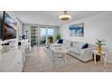 Bright living room with a comfortable sofa, stylish decor, and a beautiful balcony at 2947 S Atlantic Ave # 601, Daytona Beach, FL 32118
