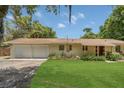 Charming home featuring an attached two-car garage and a well-maintained, lush green lawn at 2990 E Central Ave, Bartow, FL 33830