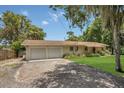 Charming home featuring an attached two-car garage and a well-maintained, lush green lawn at 2990 E Central Ave, Bartow, FL 33830