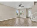 Inviting living room featuring tile floors, natural light, and modern ceiling fan at 3009 Park Ridge Ave, Mulberry, FL 33860