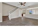 Open living room featuring tile floors and staircase, seamlessly connecting to the kitchen at 3009 Park Ridge Ave, Mulberry, FL 33860