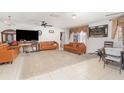 Spacious living room with tile floors, ceiling fan, comfortable sofas, and lots of natural light at 3280 Pinto Dr, Kissimmee, FL 34746