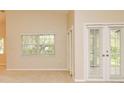 Bright living room featuring large windows and neutral tones at 33042 Lake Bend Cir, Leesburg, FL 34788