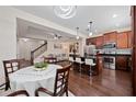 Open-concept kitchen with dark cabinets, stainless steel appliances, and a large island at 3508 Brighton Park Cir, Belle Isle, FL 32812