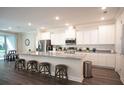 Modern kitchen with stainless steel appliances, an island, and sleek countertops at 351 S Sunset Ave, Mascotte, FL 34753