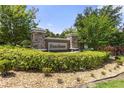 Stone signage at Foxchase community entrance surrounded by manicured shrubbery at 3637 Foxchase Dr, Clermont, FL 34711