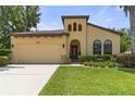 Charming home featuring a well-manicured lawn, two-car garage, and a unique architectural design at 3637 Foxchase Dr, Clermont, FL 34711