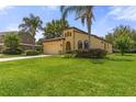 Charming home featuring a well-manicured lawn, two-car garage, and a unique architectural design at 3637 Foxchase Dr, Clermont, FL 34711