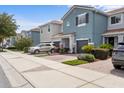 Exterior shot of charming two-story townhomes, each with a private garage and manicured front yards at 366 Reed Grass Dr, Oviedo, FL 32765