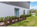 Charming home exterior with a beautifully landscaped yard and a blue front door at 378 Cape Honeysuckle Pl, Sanford, FL 32771