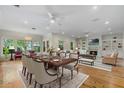 Open-concept living and dining area with hardwood floors, fireplace, and abundant natural light at 408 W Pearl St, Minneola, FL 34715