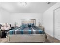 Cozy main bedroom with a decorative bed frame, carpet flooring and ample natural light at 411 Ridges Dr, Dundee, FL 33838