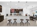 Stylish kitchen with granite countertops, stainless steel appliances, pendant lighting, and a breakfast bar with seating at 4432 Desert Rose Ave, Kissimmee, FL 34746