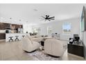 Bright and spacious living room featuring modern decor, neutral colors, and ample natural light from large windows at 4432 Desert Rose Ave, Kissimmee, FL 34746