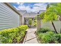 Beautiful walkway to front door with lush landscaping and mature trees at 463 Warrenton Rd # 463, Winter Park, FL 32792