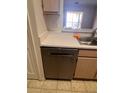 Modern stainless steel dishwasher installed next to the sink and wooden cabinets at 5459 Vineland Rd # 4310, Orlando, FL 32811