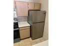Efficient kitchen setup featuring stainless steel refrigerator and modern electric stove at 5459 Vineland Rd # 4310, Orlando, FL 32811