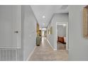 Bright and spacious hallway featuring tile flooring, recessed lighting, and access to various rooms at 7834 Minutemen Loop, Winter Garden, FL 34787