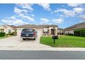 Beautiful single-story home with a well-manicured lawn, tasteful landscaping, and a private two-car garage at 8865 Se 119Th St, Summerfield, FL 34491