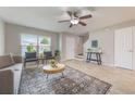 Cozy living room boasts tile floors, a ceiling fan, and neutral decor, creating a welcoming space at 9494 Lake Lotta Cir, Gotha, FL 34734