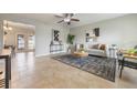 Bright living room features tile floors, ceiling fan, and cozy decor with access to the dining room at 9494 Lake Lotta Cir, Gotha, FL 34734