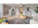 Inviting living room with tile floors, modern decor, and easy access to the dining area and staircase at 9494 Lake Lotta Cir, Gotha, FL 34734