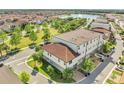 Aerial view showcases the townhome's location near a scenic lake, pool, and well-maintained green spaces at 9533 Mere Pkwy, Orlando, FL 32832