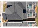 An aerial view showing the roof, screened-in pools, and proximity to the street at 1070 Splash Shot Pl, Davenport, FL 33896