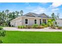 Charming single Gathering home features a paved driveway and attached garage, surrounded by lush landscaping at 1536 Pine Island Rd, Kissimmee, FL 34744
