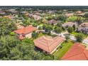 An aerial view of a residential area with tile roofs and lush green landscaping at 169 Verde Way, Debary, FL 32713
