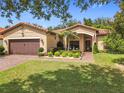 Charming one-story home with a well-manicured lawn, tile roof, and inviting front entrance at 169 Verde Way, Debary, FL 32713