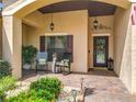 Inviting front porch with rocking chairs, decorative accents, and a charming entrance at 169 Verde Way, Debary, FL 32713