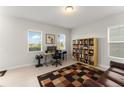 Bright office space featuring a bookshelf and large windows offering natural light at 1787 White Feather Loop, Oakland, FL 34787