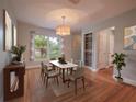 Well-lit dining room featuring hardwood floors, modern lighting, and a large window with a view at 2100 Forest Cir, Orlando, FL 32803