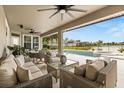 This outdoor patio features ample seating and a beautiful view of the pool and landscaped backyard at 218 Pebblerock Ct, Orlando, FL 32828