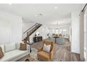 Open-concept living area with hardwood floors, neutral decor, and staircase at 2233 Valentine Aly, Orlando, FL 32804